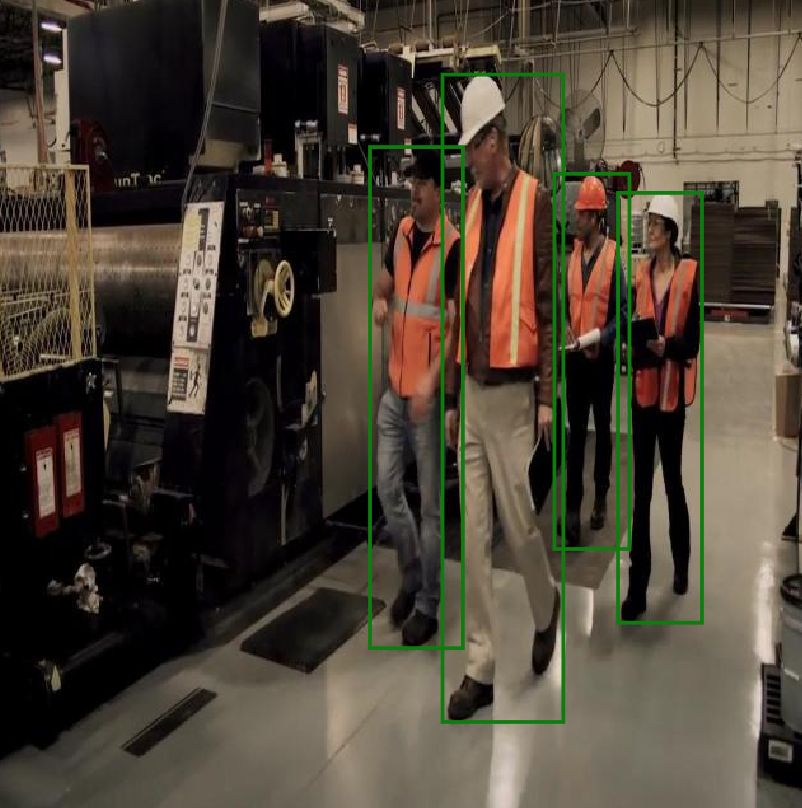 Indoor factory — all workers wearing orange safety vests (green boxes)
